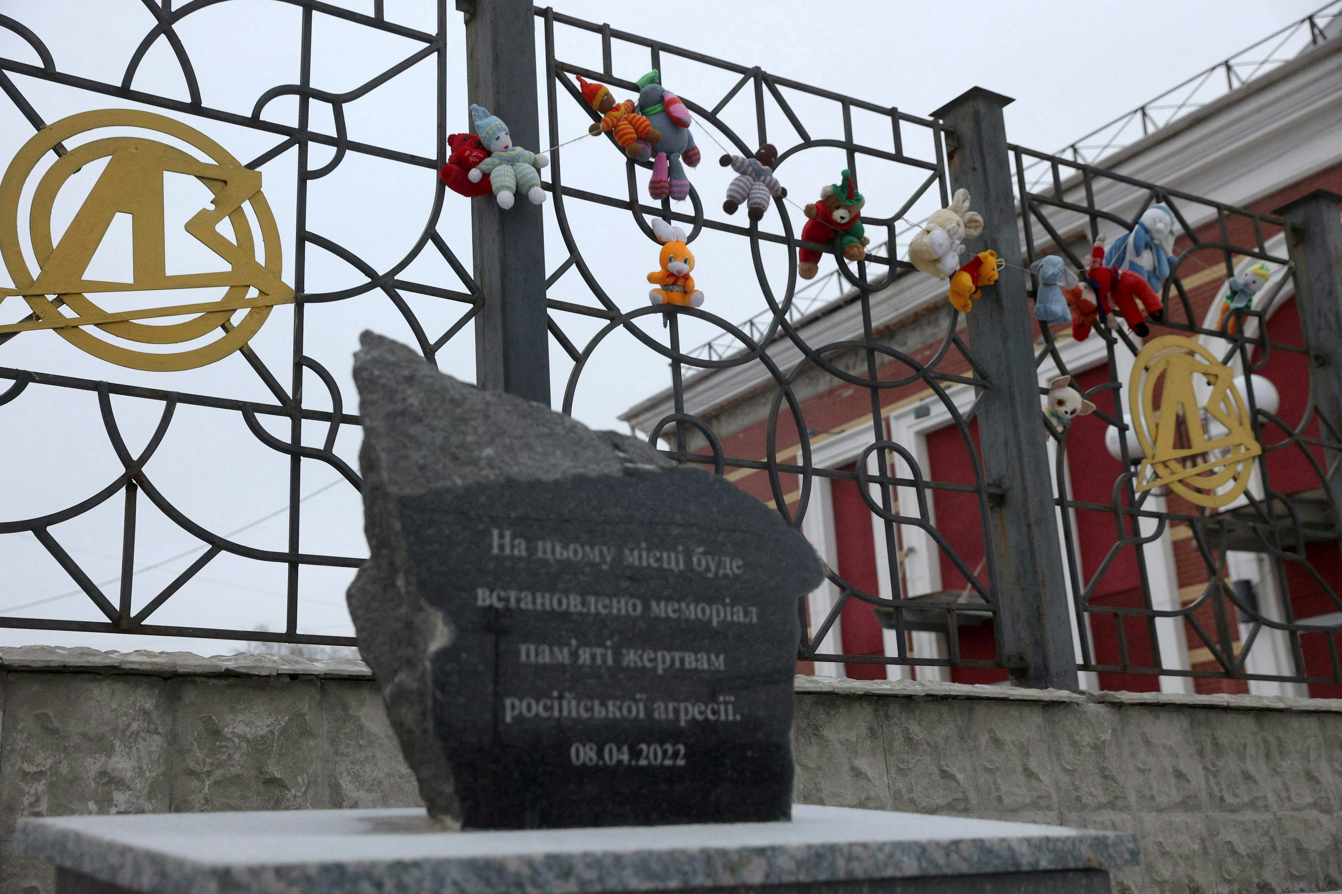 Legetøj og en mindesten ved jernbanestationen i Kramatorsk