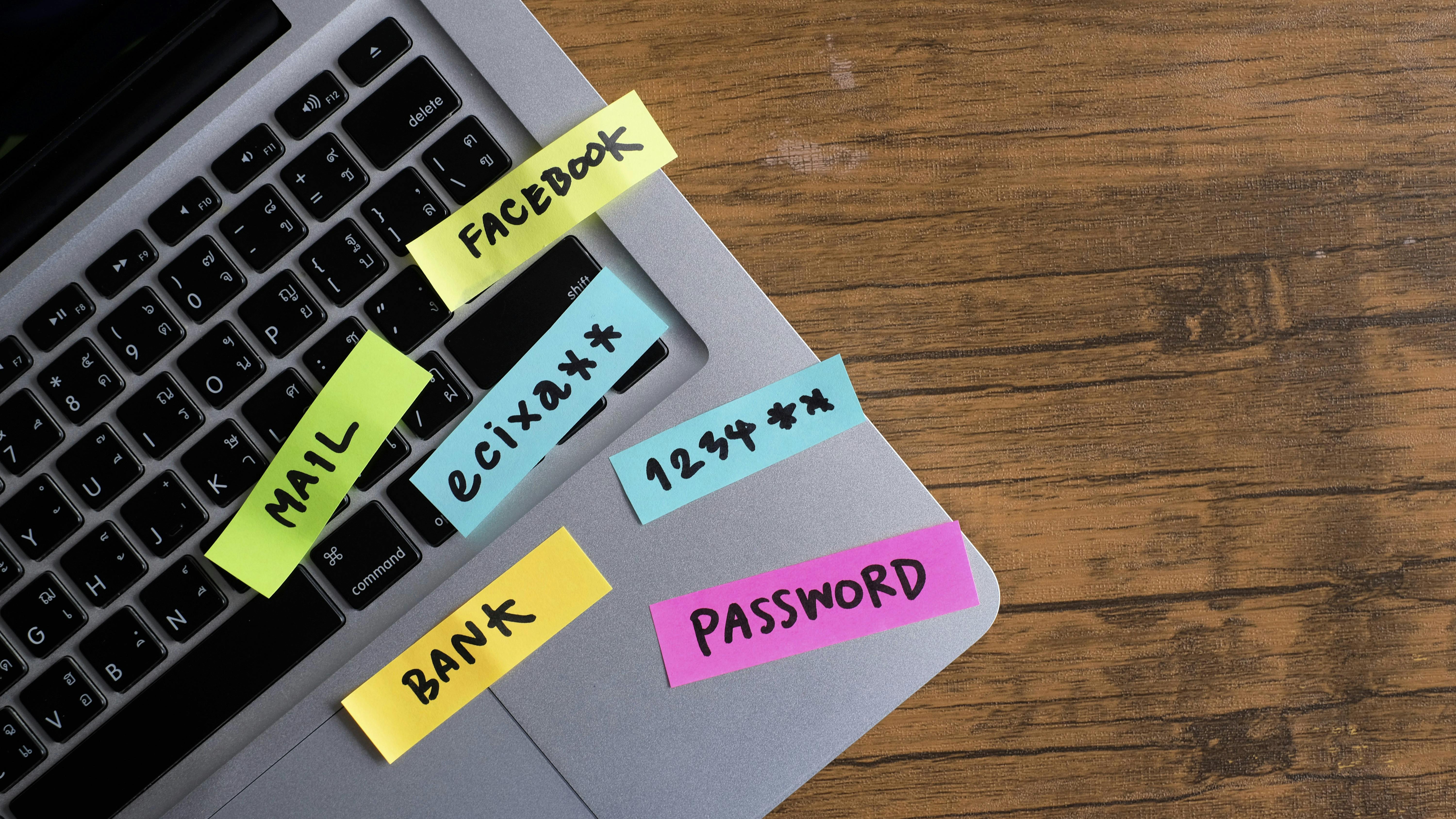 password, mail, bank, facebook, message concept written post it on laptop keyboard.	