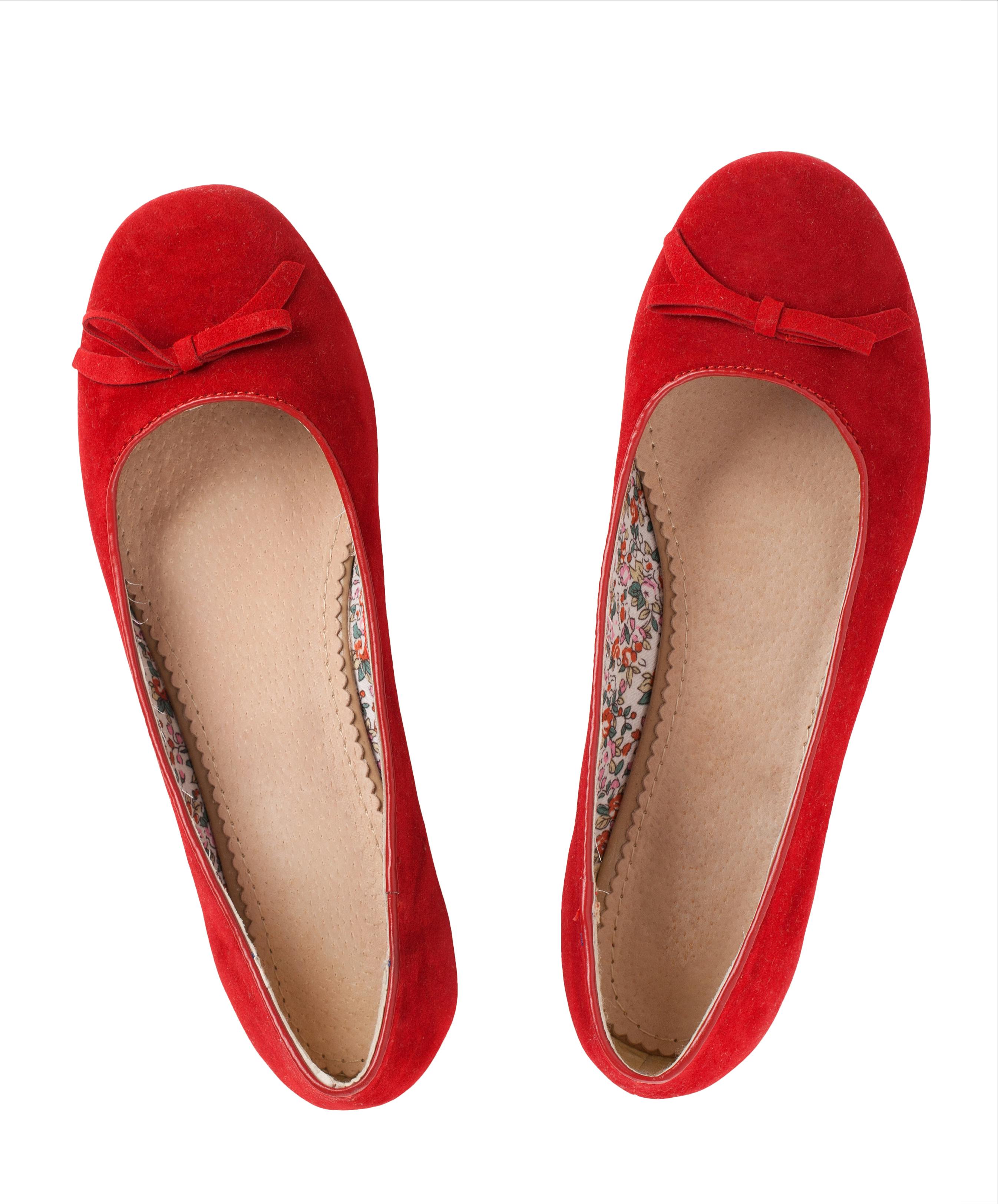 A pair of red flat shoes over white background