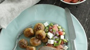 Skiveskåret svinemørbrad, der ledsages af rosmarinstegte kartofler og salat med edamamebønner og vandmelon